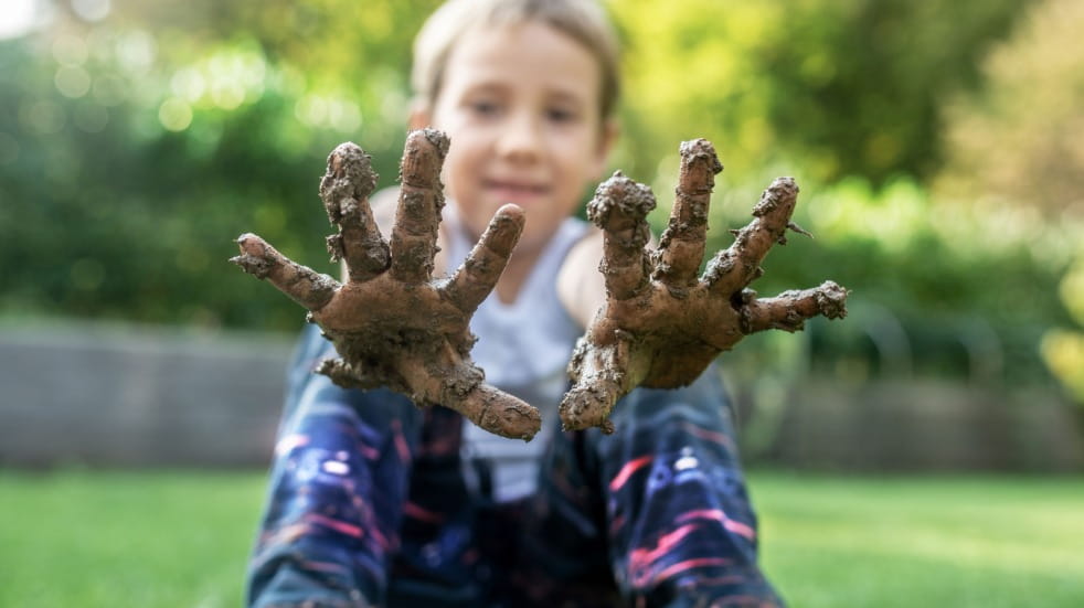 Child with muddy hands